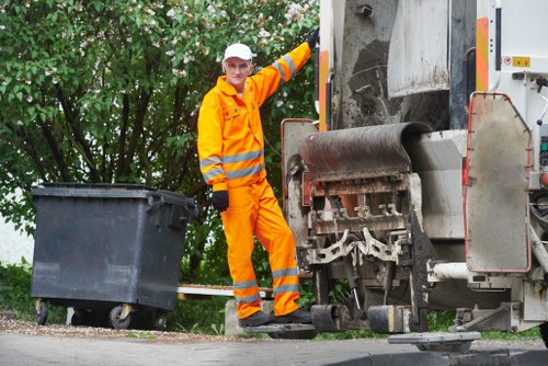 Workers managing construction debris properly